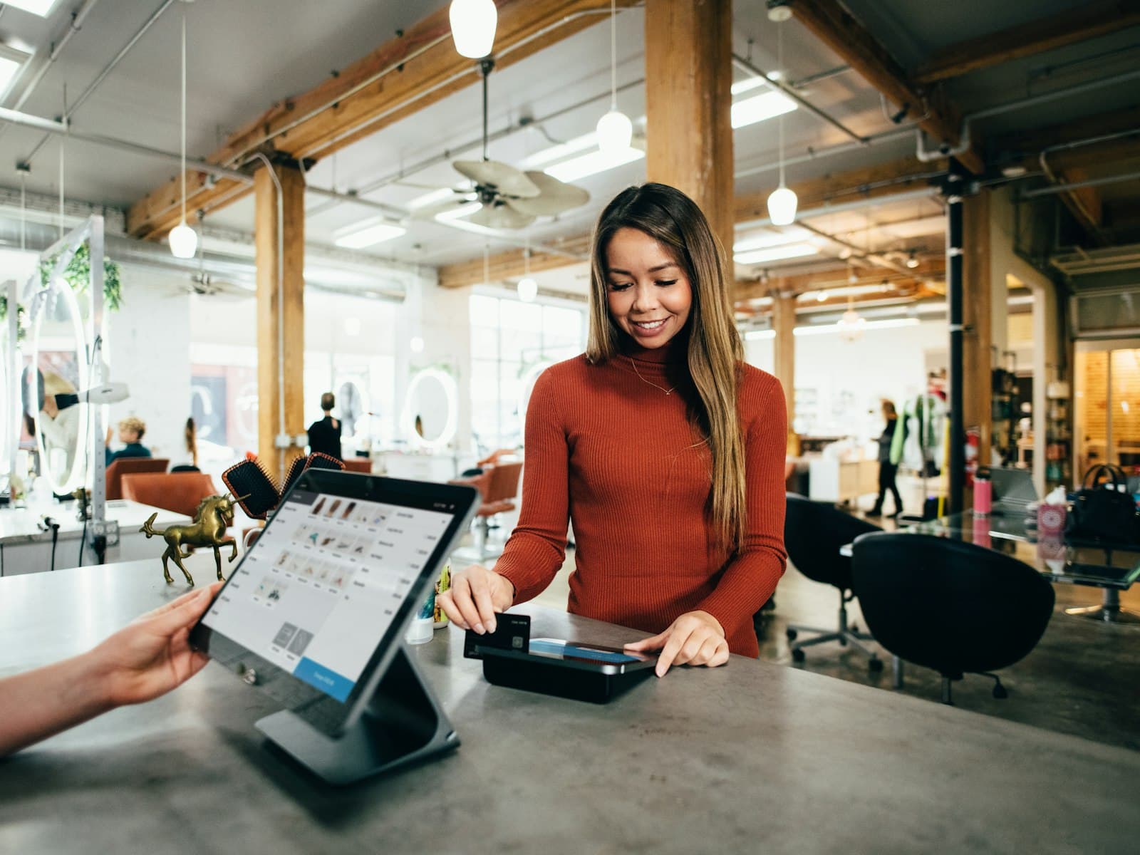 Cliente réglant son achat par carte au comptoir d’une boutique